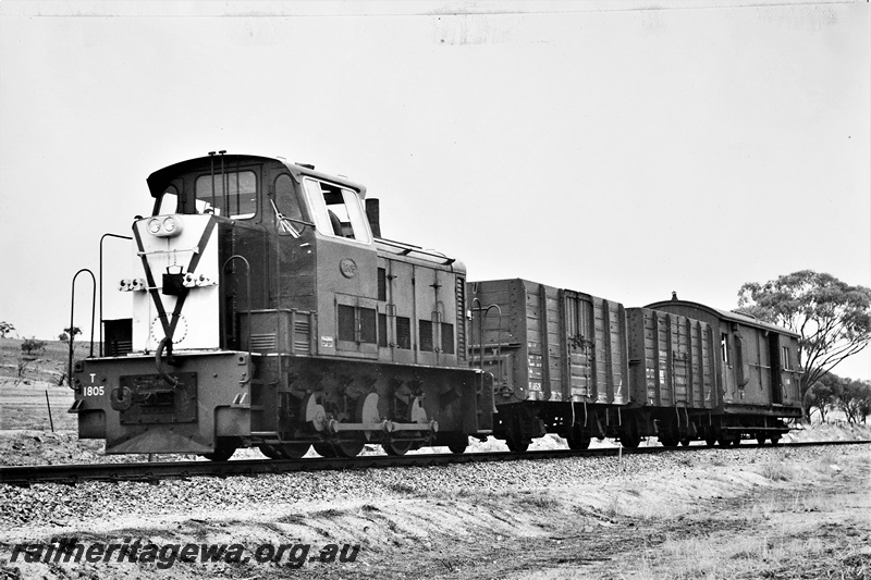 P21278
T class 1805, on goods train comprising two wagons and a van, Spring Hill, ER line, front and side view 
