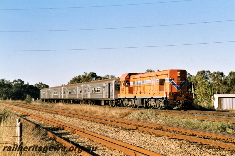 P21353
Westrail loco, A class 1504 in the orange with blue stripe livery heading a rake of Queensland suburban  carriages off the Woodbridge Triangle towards Forrestfield, view along the train
