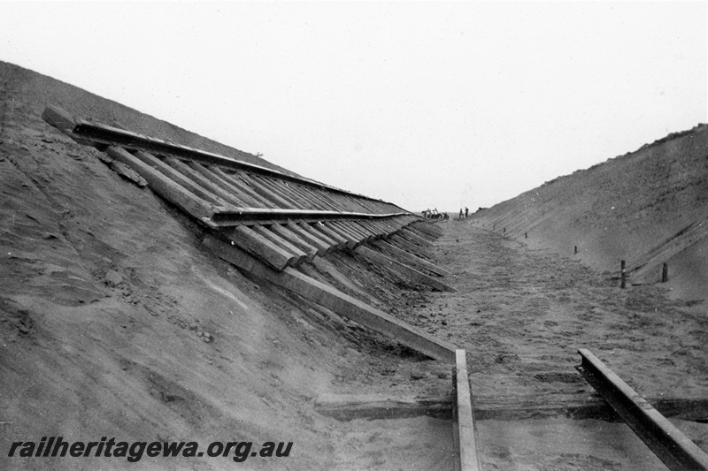 P21360
Rails on sleepers, cutting, workers, Indarra deviation, NR line, track level view, c1936
