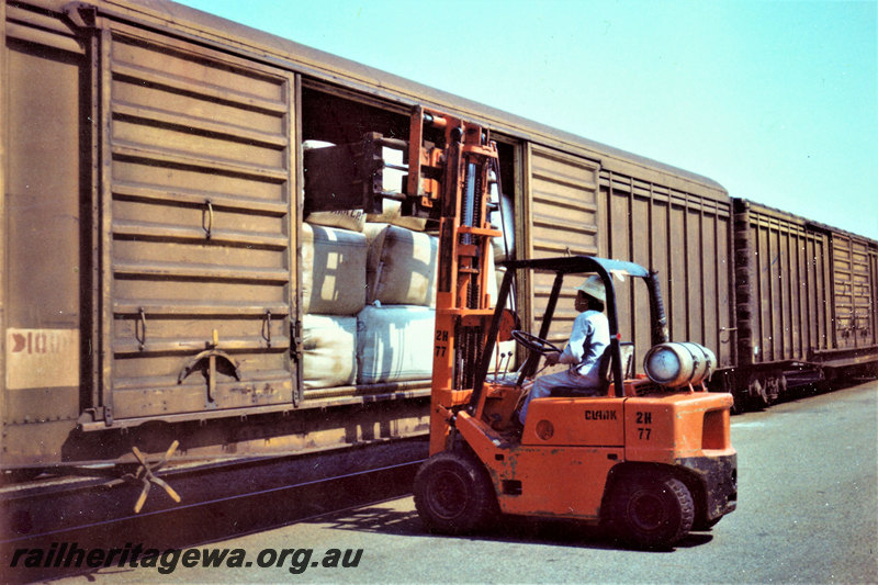 P22867
WBAX class van, being loaded by forklift, other vans, Robb's Jetty, FA line, trackside view
