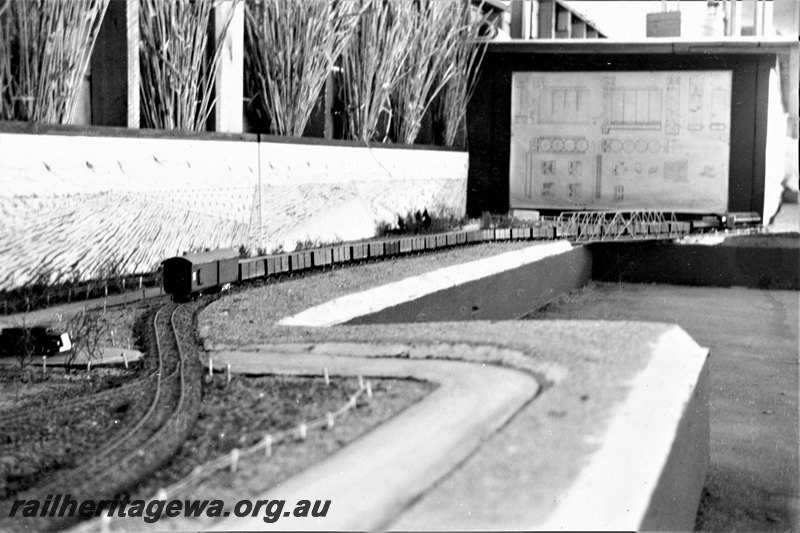 P22887
Model S class loco on wheat train of GE class wagons, scale 1/4 inch=1ft, in bulk handling exhibit at Royal Show Perth, made at Midland Junction by WAGR and Co-Operative Bulk Handling, long shot
