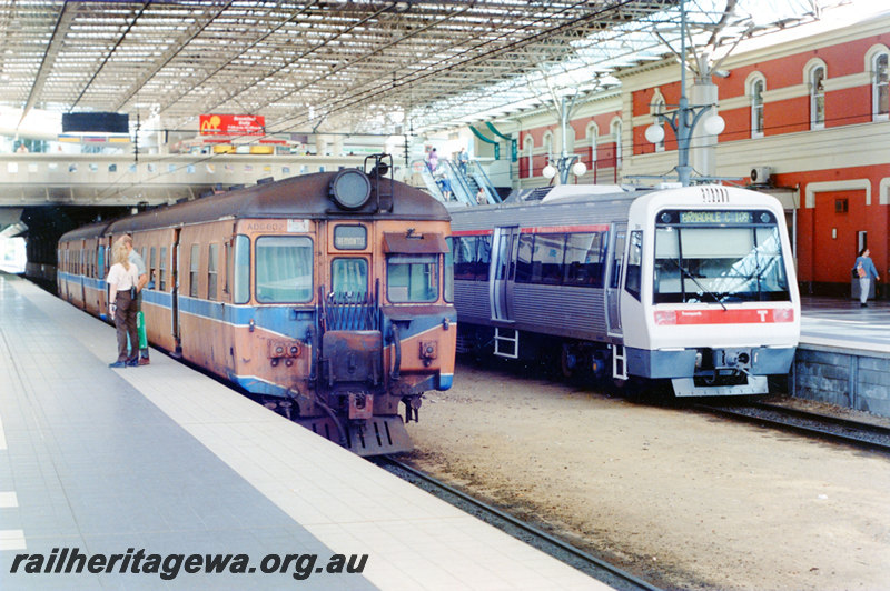 P22897
ADG class 602 leading DMU with Fremantle sign board, EMU with Armadale C109 sign board, passengers, escalators, station building, roof, Perth City station, ER and SWR lines, side and end views from platform
