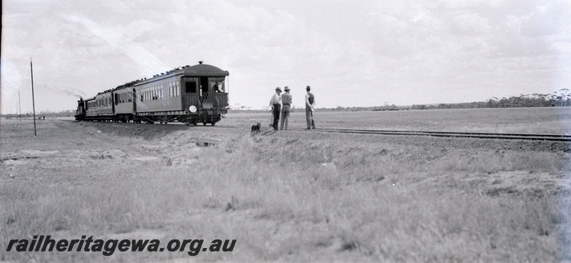 P22904
Commissioner's Tour train, three men standing on tracks, rural setting, ground level view
