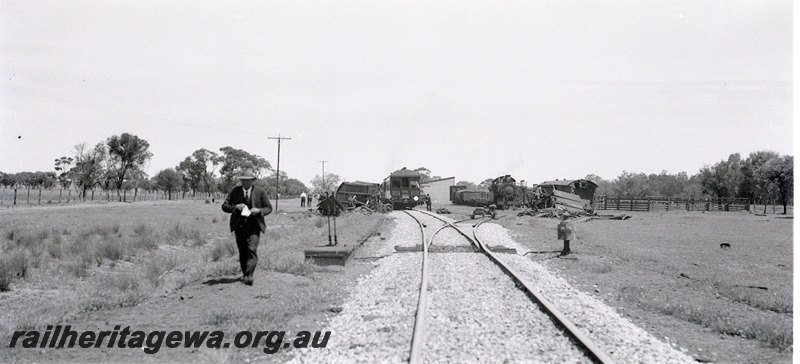 P22909
Rear end collision of No 66 Goods and AKRU 63 Goods at Frenches EM line on 22 October 1940 3 of 3, station building, points, official, long view of crash site from trackside
