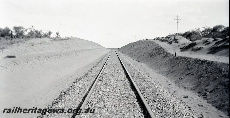 P22912
Regrading & Deviation at Indarra NR line 30 June 1935 3 of 7, view of finished trackwork, cutting, ground level view
