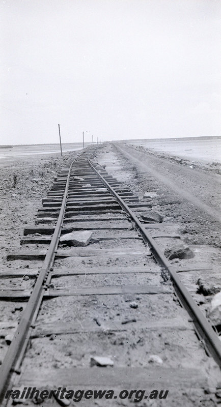 P22936
Aftermath of floods at Port Hedland PM line in January 1939 2 of 3, washed away tracks, view from track level
