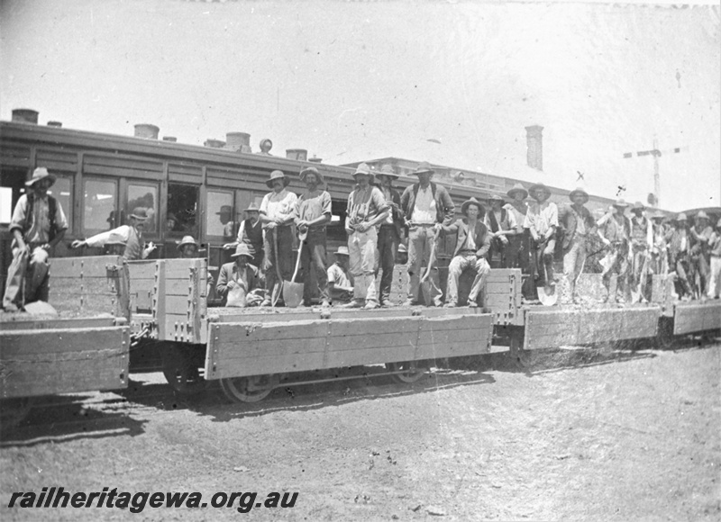 P23024
Works train of wagons with drop down sides, workers equipped with shovels aboard, signal, other carriages, MR line, Midland Railway Co era, view from trackside
