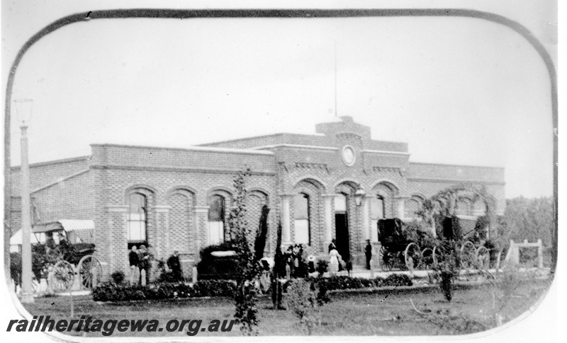 P23093
Station building, with clock and columns, horse drawn carriages and people, view of faade of the first Perth Station, ER line
