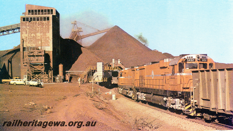 P23108
Mount Newman Mining  Alco C636 class 5452 and another C636 class entering the loadout tunnel at Mount whaleback iron ore mine,  general view of the area
