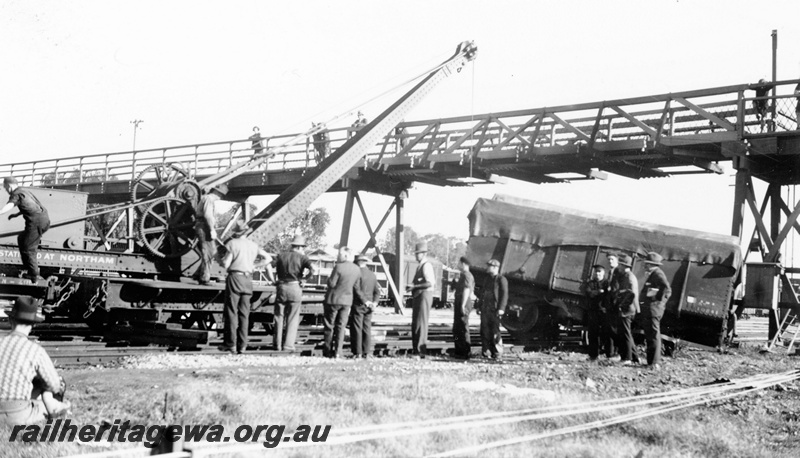 P23115
Cowans Sheldon hand breakdown crane lifting a derailed K class wagon, workers and onlookers, overhead footbridge, Northam, ER line, 
