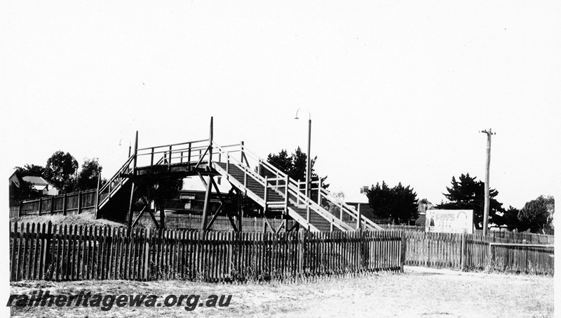 P23120
Pedestrian footbridge, picket fence, advertising sign, Daglish, ER line
