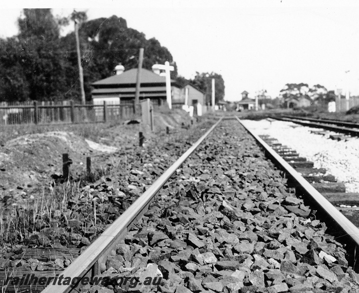 P23129
Station buildings, platforms, signals, track after ballasting, Guildford, ER line,  view along the track looking west
