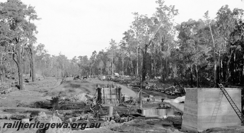 P23132
Commissioner's tour to the south west, railway construction in the forest, bridge pylons being constructed,  Collie, BN line, ground level view
