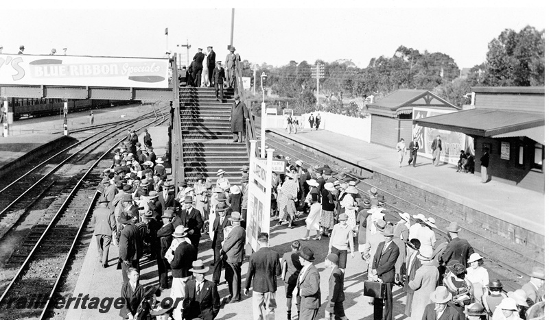 P23140
Crowded platforms, station buildings, station nameboard, overhead footbridge, signal, tracks, Claremont, ER line, elevated view, Royal Show train
