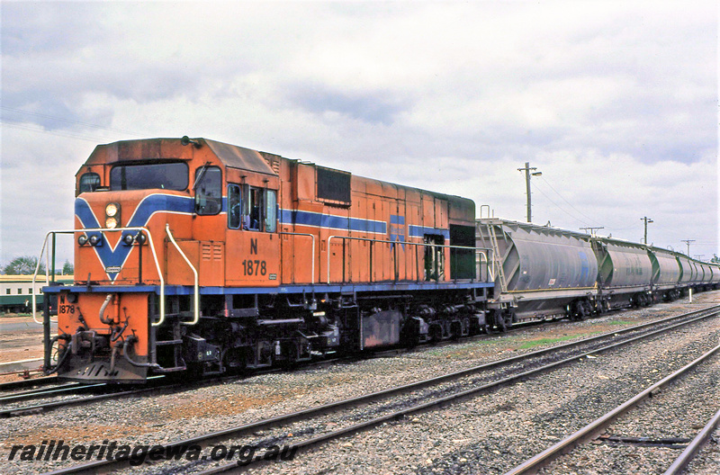 P23216
N class 1878, on train of hopper wagons, Pinjarra, SWR line, front and side view
