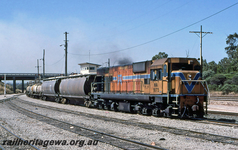 P23217
NA class 1973 on caustic alumina train, signal box, road bridge, Kwinana, side and front view
