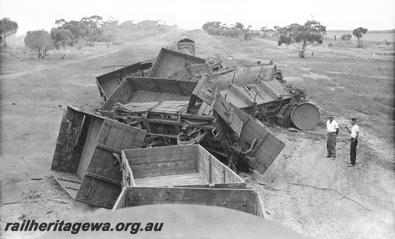 P23236
Derailment, mainly empty four wheel wagons, raised view looking along the train steam locomotive on head of train., Indarra, NR line., see also P03261
