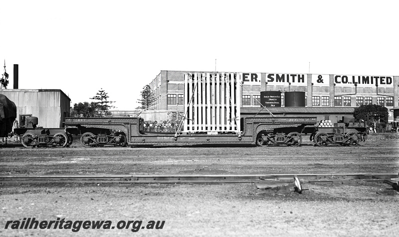 P23268
QX class 2300 trolley (well) wagon , crated heavy load at Fremantle. ER line. Side view
