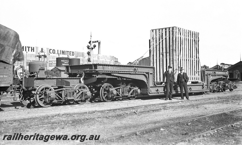 P23269
QX class 2300 trolley (well) wagon , crated heavy load at Fremantle. ER line. End and side view
