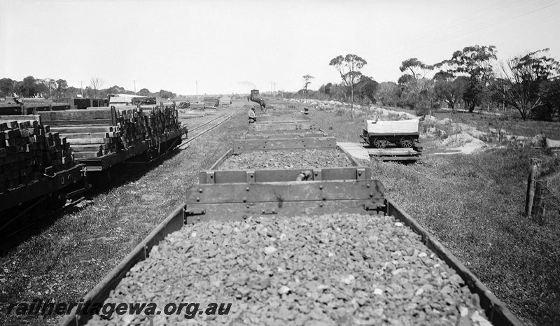 P23288
H class wagons loaded with ballast, QA class wagons loaded with sleepers, unknown location., view along the train
