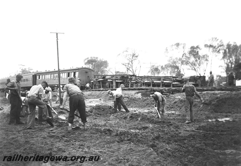 P23289
Mt Kokeby head on crash. Workers clearing damage, steam locomotive on its side in background. GSR line
