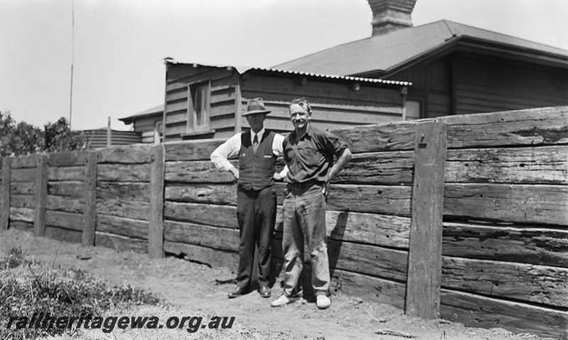 P23302
Brunswick Junction - 2 WAGR employees standing alongside timber sleeper fence. SWR line 
