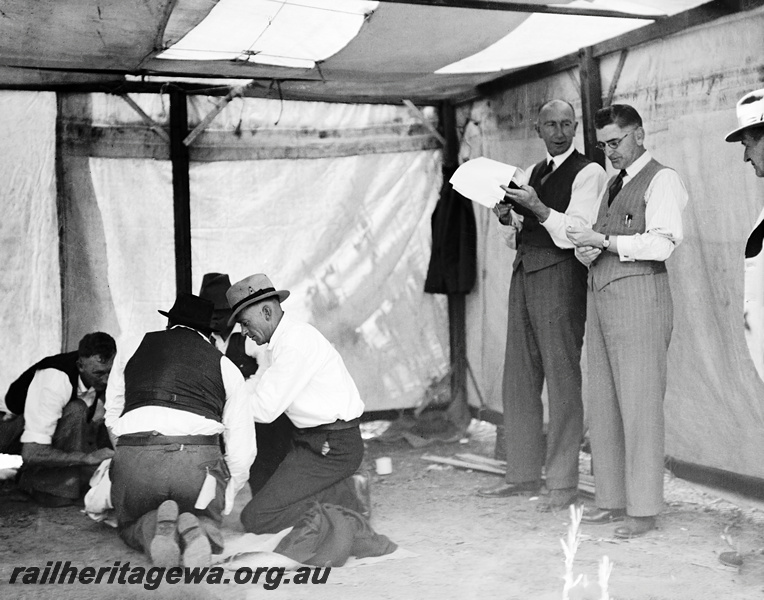 P23325
Sawyers Valley - WAGR ambulance competition, employees viewing demonstration, patient on ground. M line  
