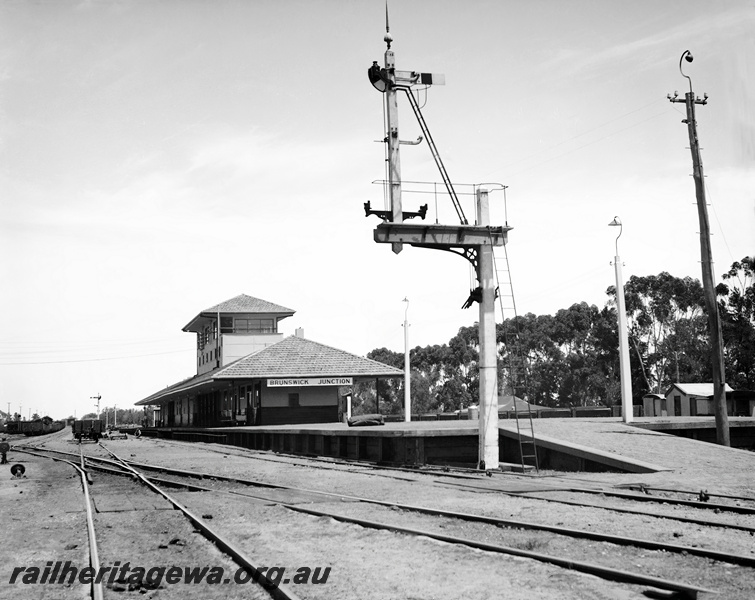 P23341
Brunswick Junction station and starting signal showing station platform, building looking south. SWR line. 
