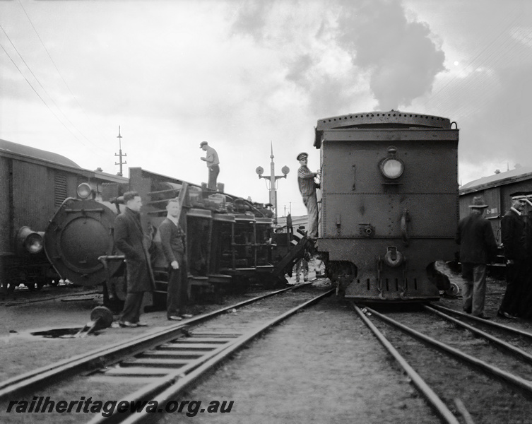 P23346
Perth Yard - N class locomotive derailed on side.  Another N class passing derailed locomotive.ER line.
