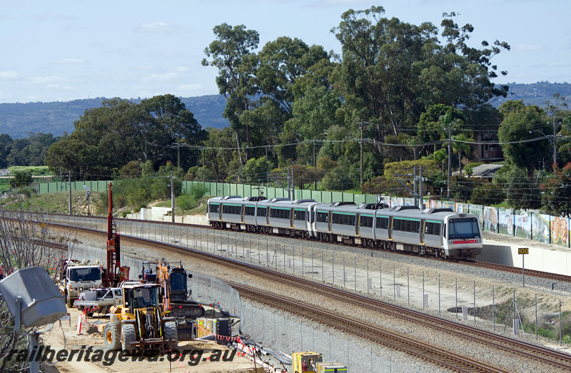 P23379
EMU A series set 20, coupled to another EMU A series set, construction equipment, trackwork, houses, Thornlie, SWR line, distant side and end view
