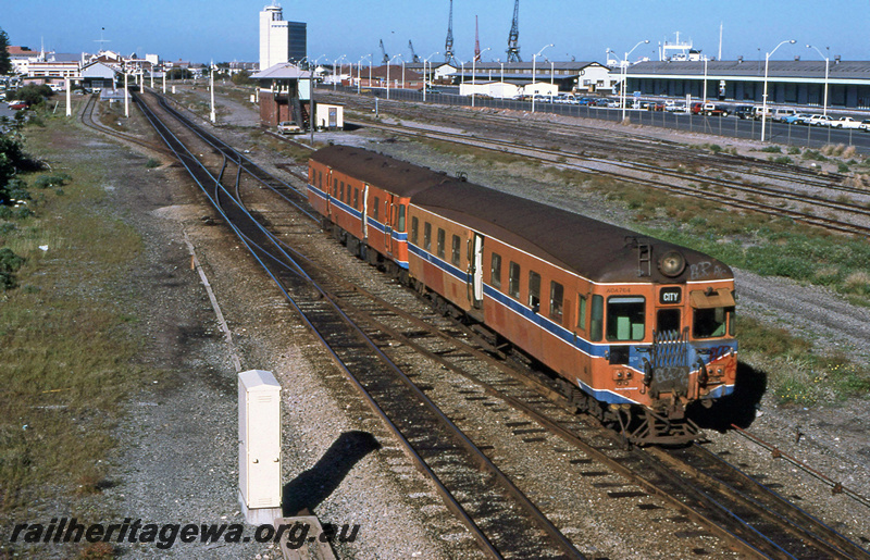 P23388
ADAV class 764, on 2 car DMU set, port authority tower, warehouses, station buildings, platforms, tracks, Fremantle, side and end view
