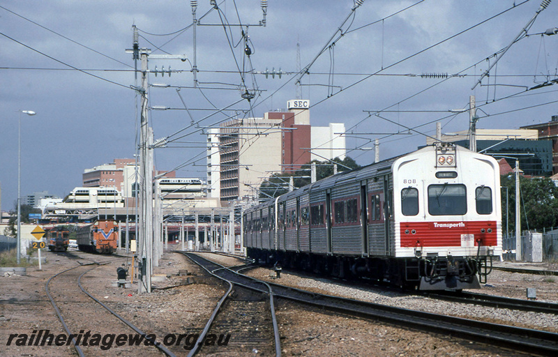 P23403
ADL class 808, on DMU set, overhead wires, another DMU, diesel loco, city buildings, Perth city station, ER line, side and end view 
