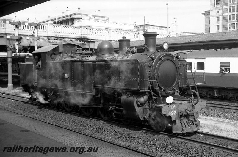 P23413
DD class 592, passenger carriage (part), water crane, bracket signals, overhead road bridge, platform edge, Perth city station, ER line, side and front view
