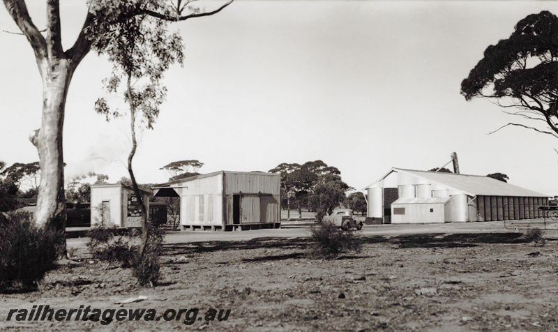 P23440
Out of shed , 4th class goods shed,,  wheat bin, truck,, Omgerup, TO line, overall view of the siding.l
