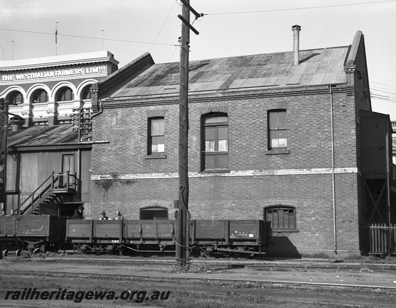 P23450
R class 2881 bogie open wagon,  E of SE office building, Westralian Farmers building, tracks, Perth ER line, track level side view from goods yard
