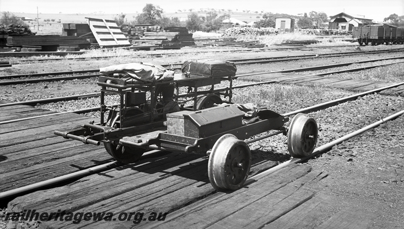 P23453
Motorised trolley in yard, wagons, tracks, sleeper crossing, end and side view from trackside
