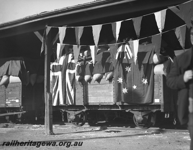 P23461
GC claas 9901 festooned with flags,loaded with chaff  to be sold in aid of Railway Queen, at Perth Goods shed, end of GA class 4938 in the view, Perth, ER line, ground level side view. See also P23460 & P23462
