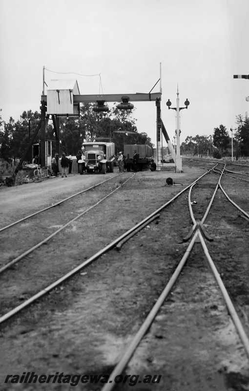 P23514
Truck with a ontainer on the back being loaded with cemant for the construction of Canning Dam,  wagons, gantry, workers, track level view, Armadale, SWR line, developed 19341200. See also P23513 & P23515 
