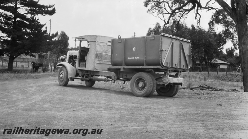 P23515
Truck with bin to be  loaded with cement for the constrction of Canning Dam, on dirt road between trees, Armadale, SWR line, road level view, developed 19341200. See also P23513 & P23514.
