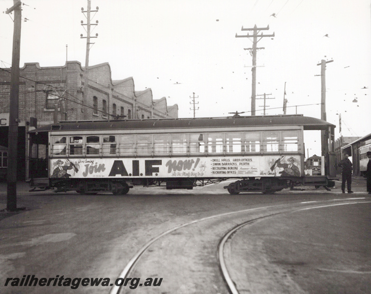 P23526
WAGT tram outside East Perth Car Barn with advertising encouraging people enlist for WW II service.
