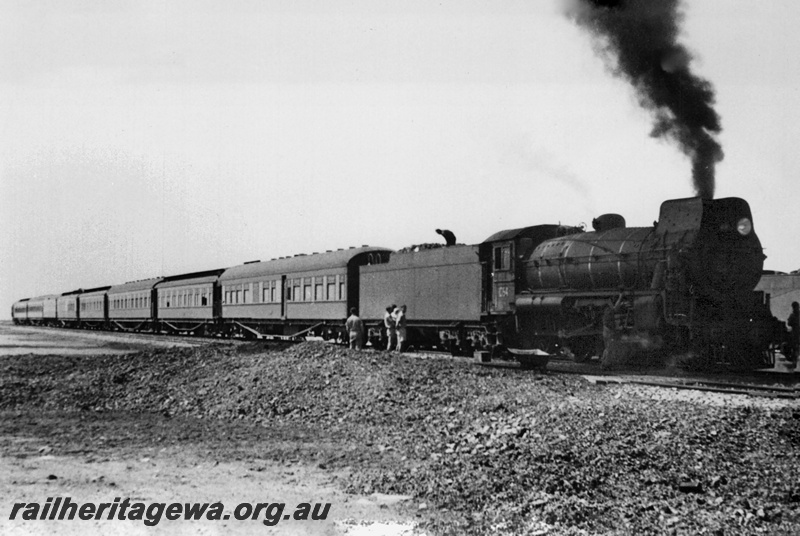 P23540
Commonwealth Railways C class 64 hauling the Trans train. The first carriage behind the locomotive is Special Services Car No. 1  which was used for bullion cartage during WW II.
