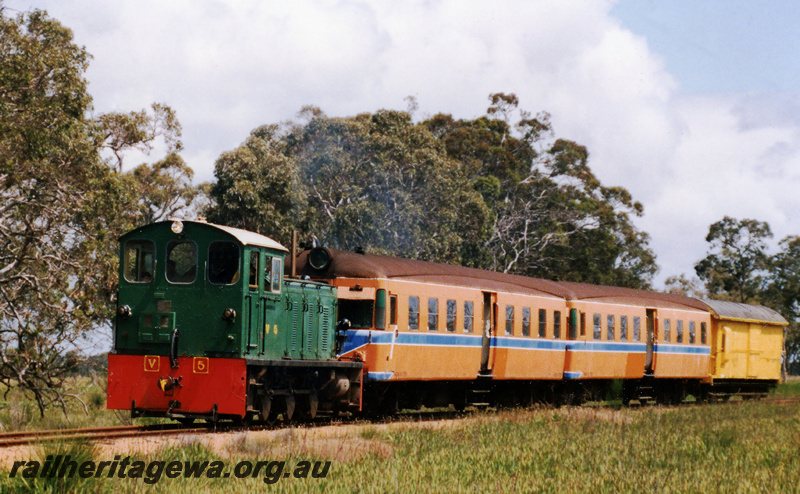 P23573
HVR ex Tasrail V class 5 hauling ADA class 52 and 751 past Meelon. The ADA  trailers  were to replace the ex Tasmanian coaches normally used on the Etmilyn  tramway services which were being used on a charter to Merredin / Bruce Rock. The trailing vehicle is brakevan ZD class 23. PN line.
