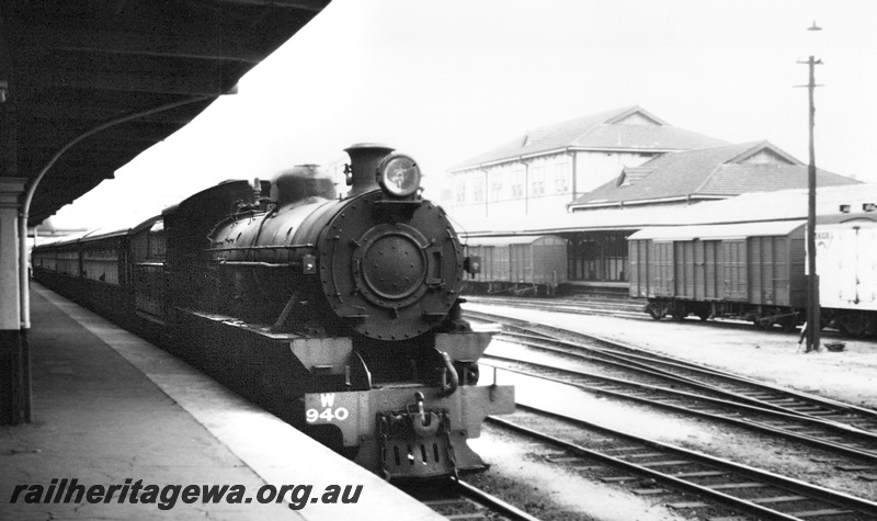 P23599
W class 940, on passenger train, goods wagons, platform, canopy, sidings, Perth station, ER line, side and front view
