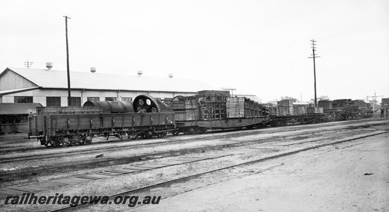 P23817
Rake of wagons comprising RB class 684, lamp, no vacuum pipe, all side doors, QAS class girder side wagon, QM class wagon, QX class wagon, trackside building, tracks, end and side view. See P23818
