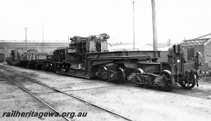 P23818
QX class trolley wagon 2300, laden with Baldwin Ormes CM50 forging press, workshop buildings, tracks, Midland, ER line, side and end view. See P23818
