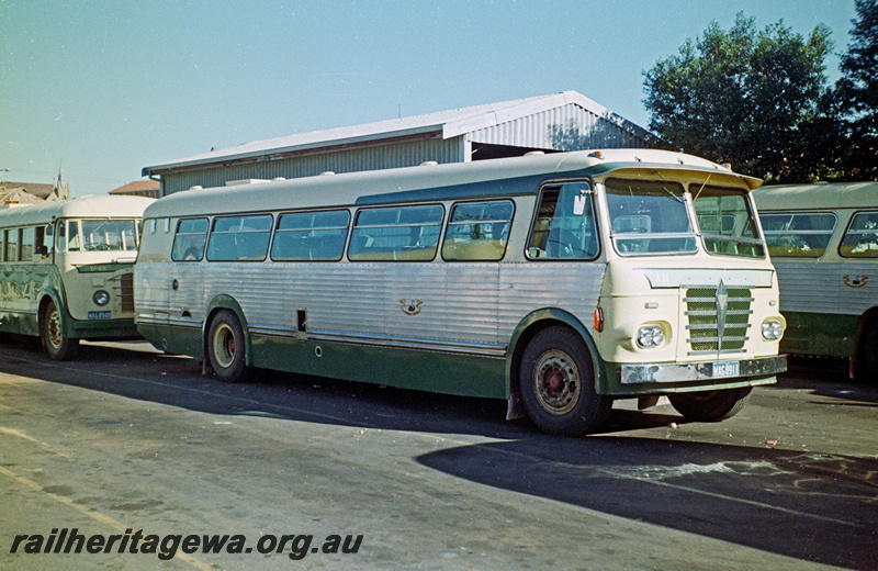 P24200
Railway Road Service  bus WAG8911, bus shed, portions of other buses, side and front view
