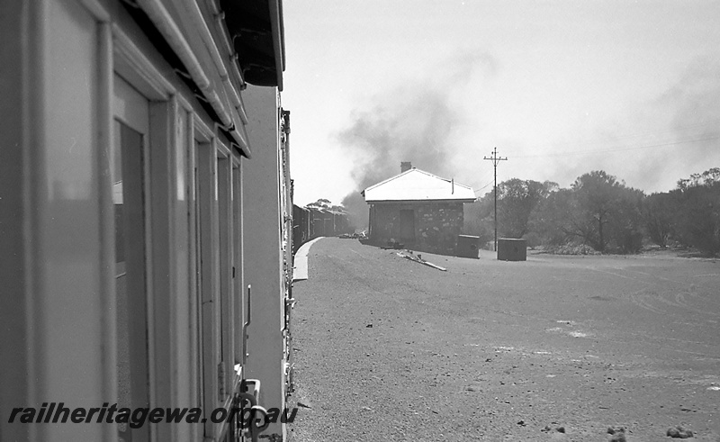 P24284
Passing through station, station building with metal roof and stone walls, smoke billowing from locomotive on front of train, Comet Vale, KL line, view from out of the train window

