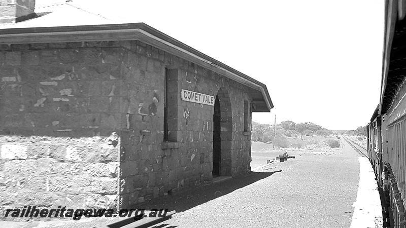 P24285
Station building of stone with metal roof, platform, train at station, Comet Vale, KL line, view from platform
