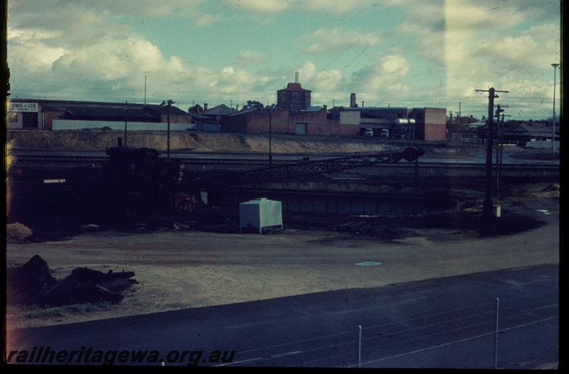 T03300
Turntable, steam crane East Perth temporary loco depot. Railway house at 34 Cheriton Street in background, 
