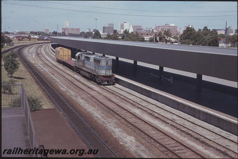 T04286
L class in original livery hauling a bogie flat wagon and a brakevan, East Perth Terminal, elevated view
